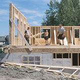 builders putting up a house